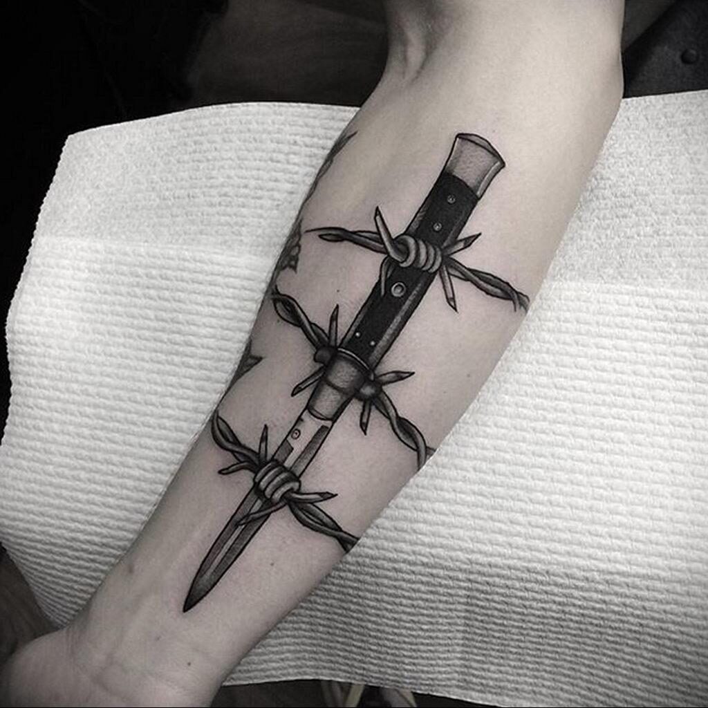 The Intricate Meaning Behind Barbed Wire Tattoos