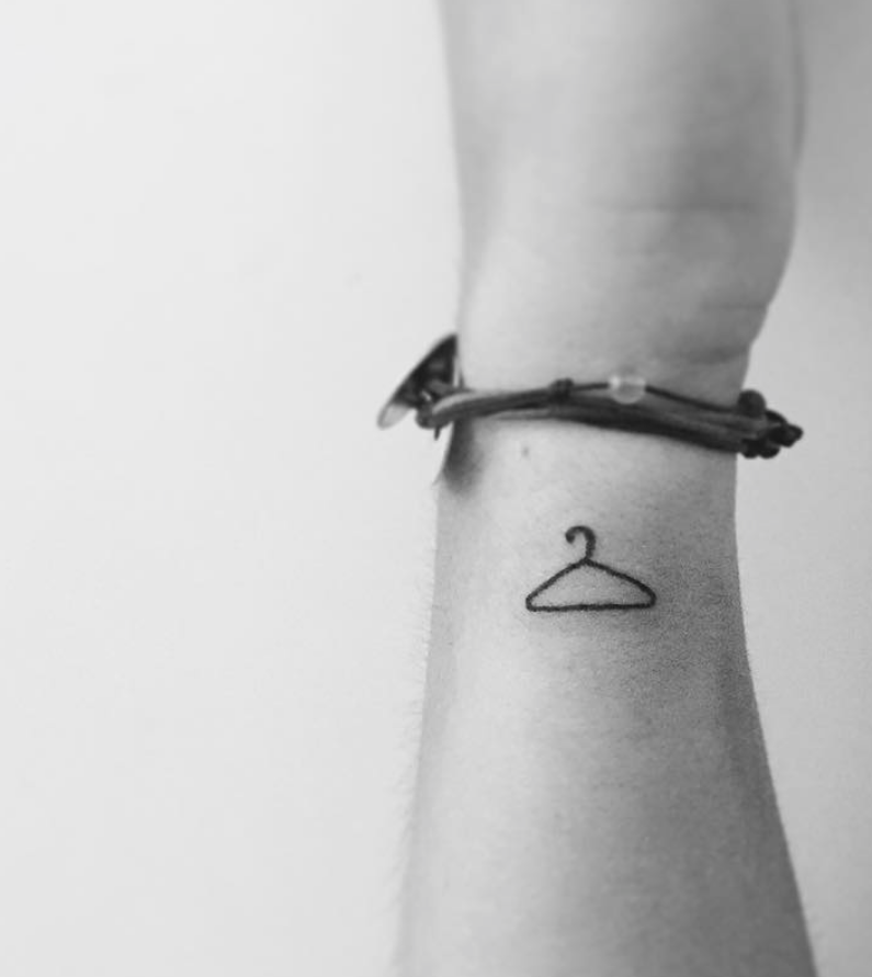 The Meaning Behind the Coat Hanger Tattoo: A Symbol of Strength and Resilience - Impeccable Nest