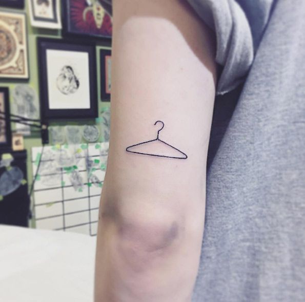 The Meaning Behind the Coat Hanger Tattoo: A Symbol of Strength and Resilience