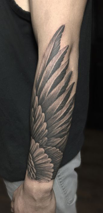 Unveiling the Mystery: What Do the Forearm Wing Tattoos Mean? - Impeccable Nest