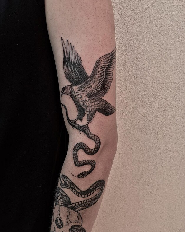 Eagle holding snake tattoo meaning