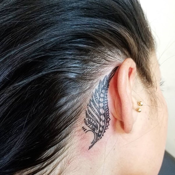 Feather Behind Ear Tattoo Meaning: Interpretation and Patterns of Tattoos featuring Feathers Placed Behind the Ear.