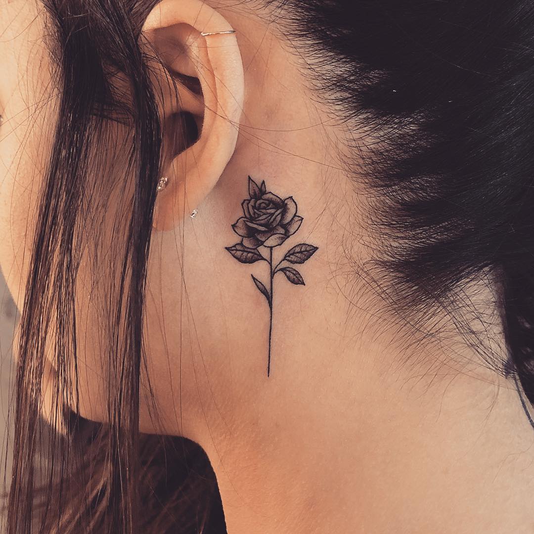 Rose Tattoo Behind Ear Meaning: The significance of designs featuring a tattoo of a rose behind the ear.